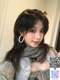 毛先に光を受けてふわりと揺れる暗棕のミディアムレイヤー